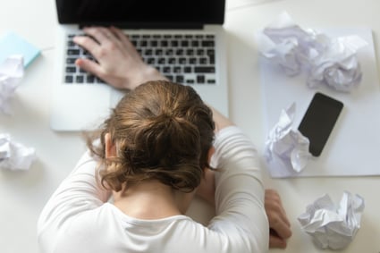 top-view-portrait-of-woman-lying-at-desk-near-the-laptop